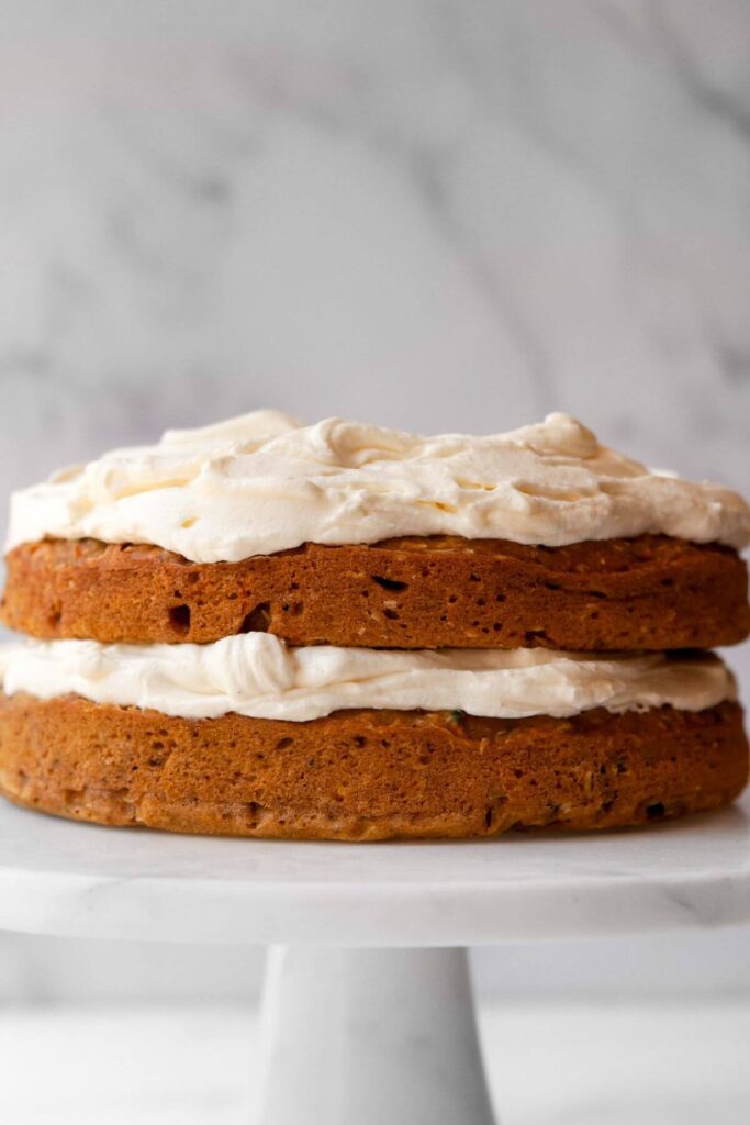 two layered pumpkin carrot cake with healthy cream cheese frosting