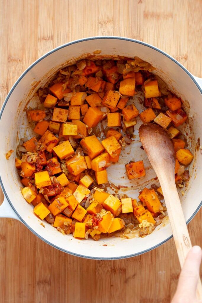 adding cubes of butternut squash and all the spices