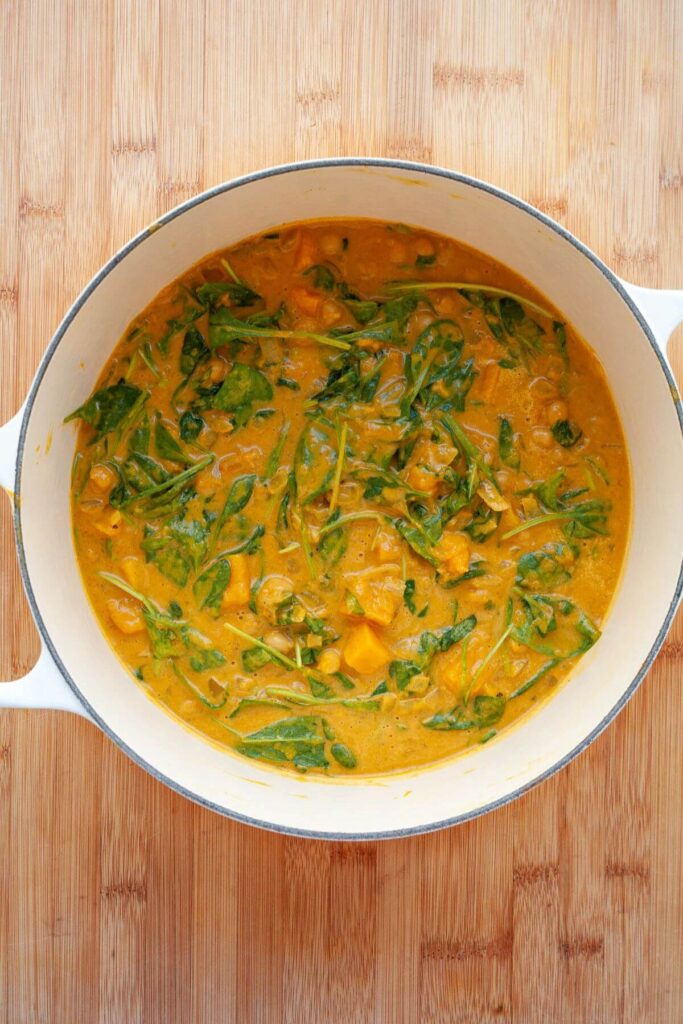 butternut squash spinach curry in durch oven pot