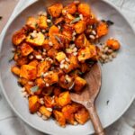 crispy air fryer butternut squash cubes tossed with sage, pine nuts and garlic