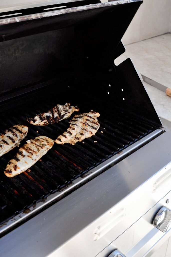 grilling yogurt marinated chicken on an outdoor grill