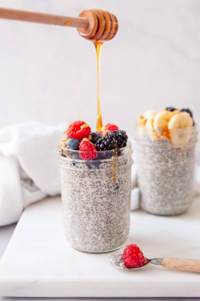 drizzling honey on top of oat milk chia pudding