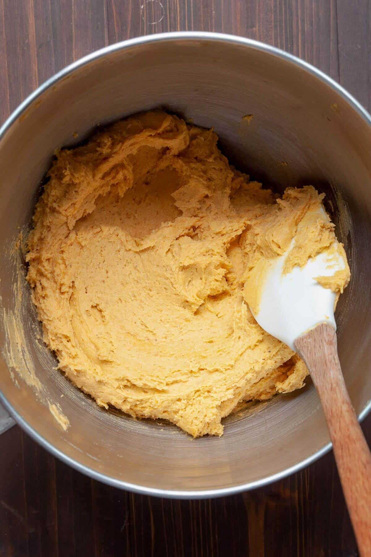 Gluten-free pumpkin cookie batter in a mixing bowl after combining pumpkin purée, Greek yogurt, egg, and dry ingredients.