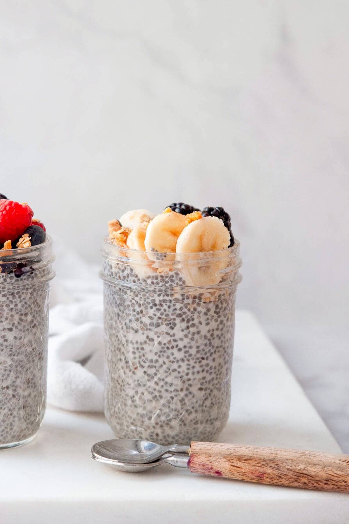 Banana chia seed pudding after soaking overnight with bananas and berries on top.