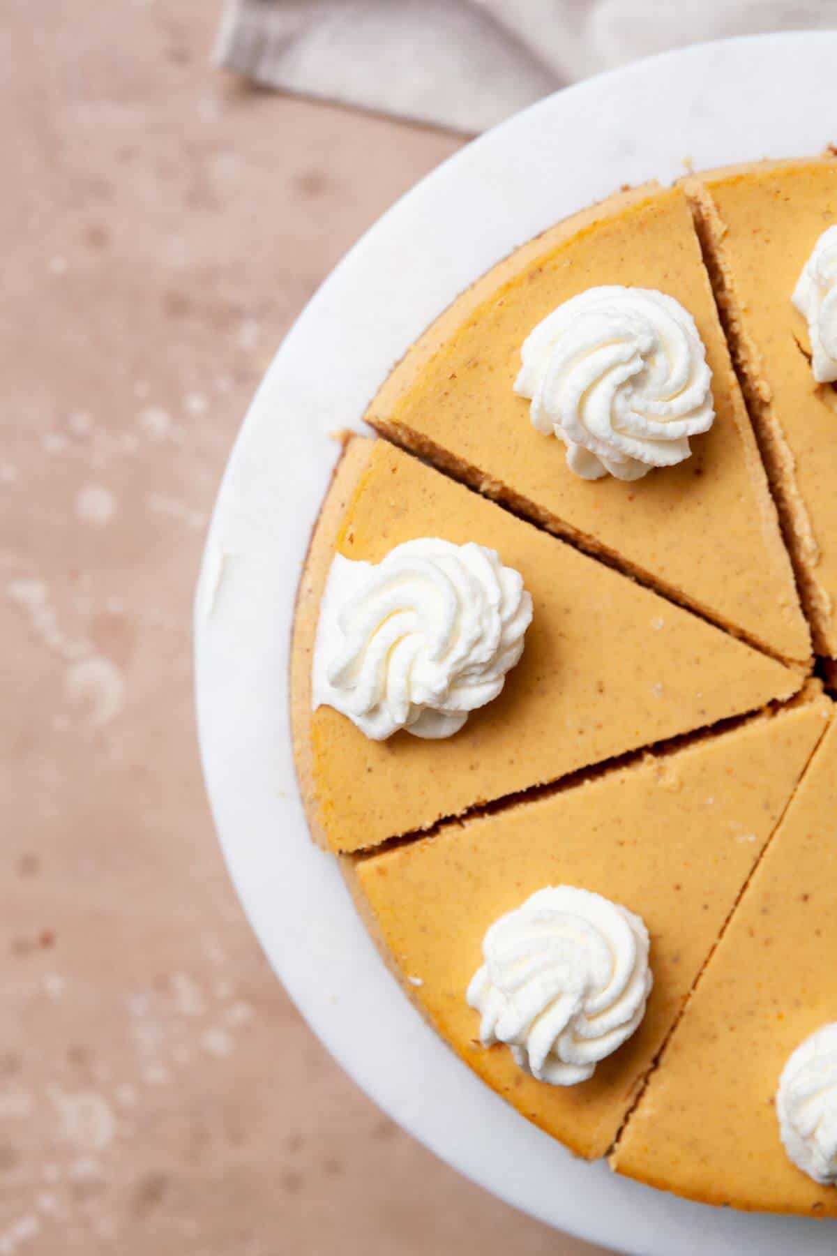 Pumpkin cheesecake made with Greek yogurt and a gluten-free graham cracker crust.