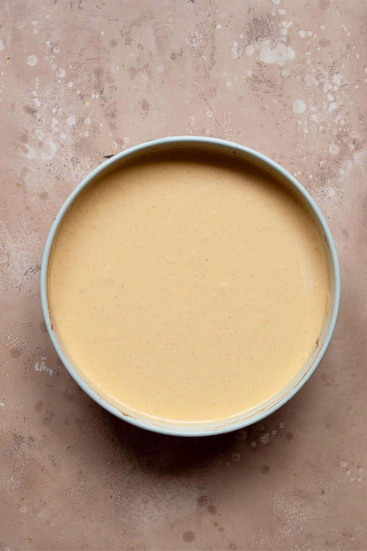 Unbaked Greek yogurt pumpkin cheesecake filling in the baking dish before baking.