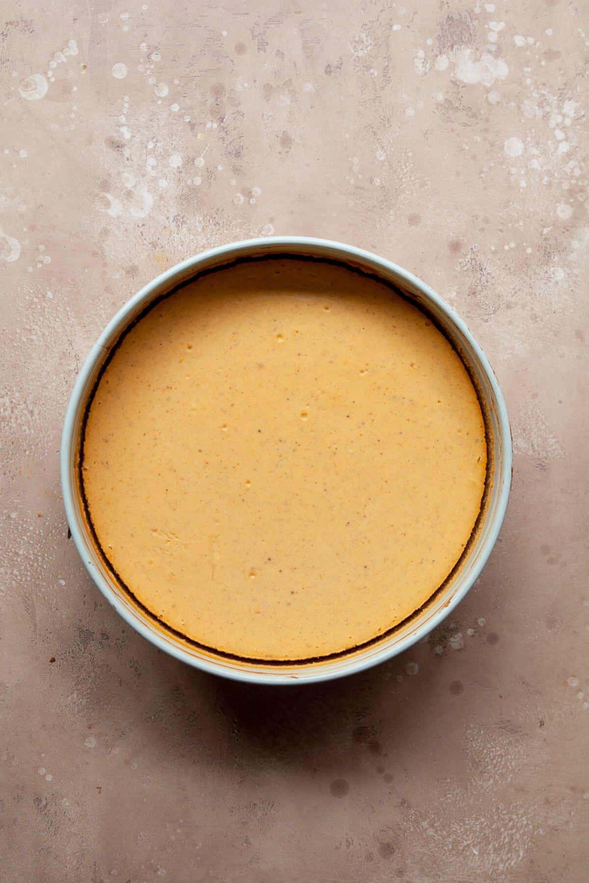 Cooled Greek yogurt pumpkin cheesecake in the baking dish after baking.