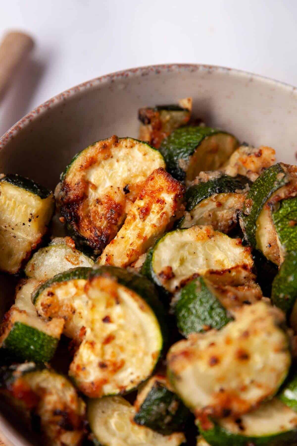 Crispiest low-carb air fryer Parmesan zucchini with golden, crunchy cheese edges.