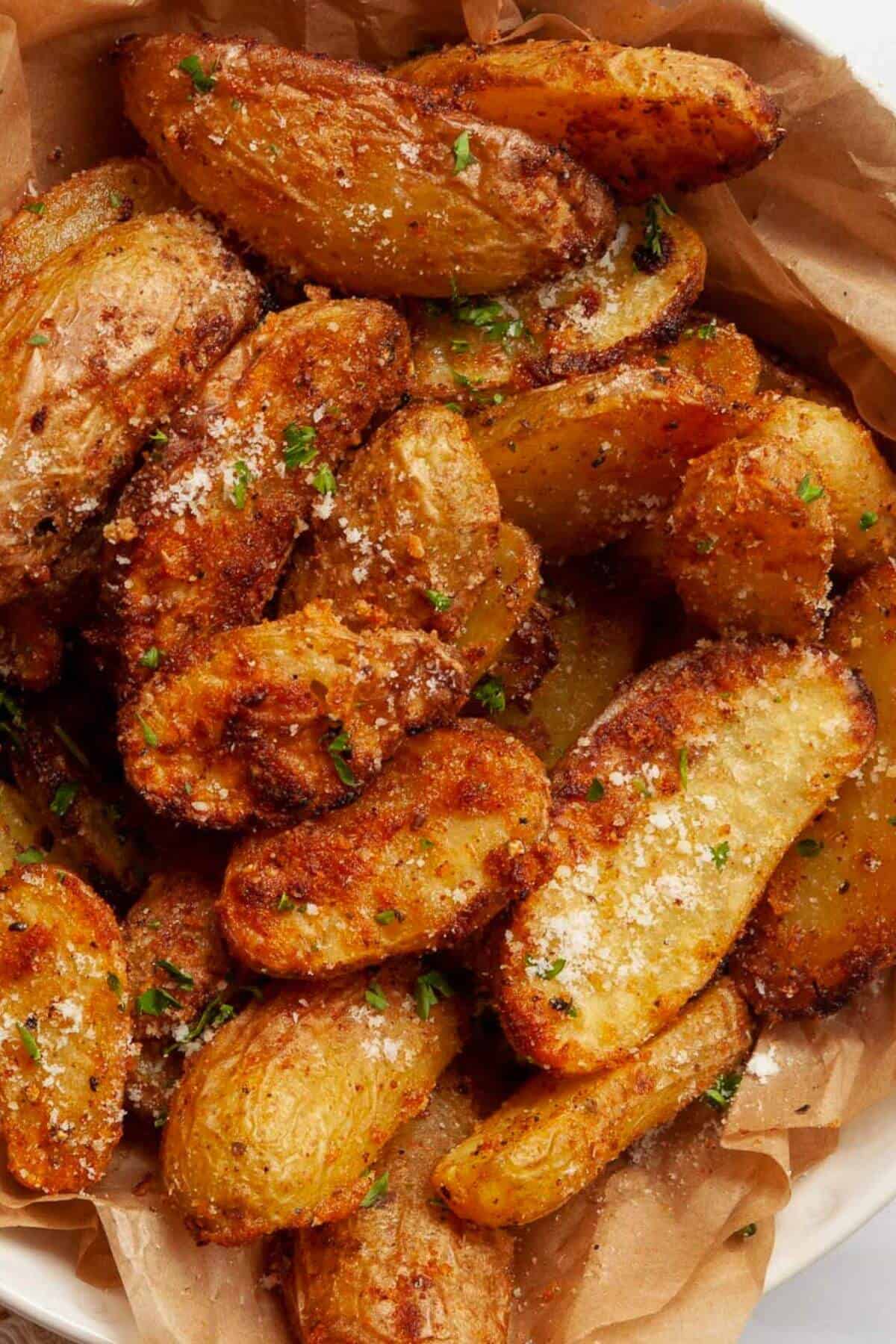 Super crispy air fryer fingerling potatoes with cheese and herbs.
