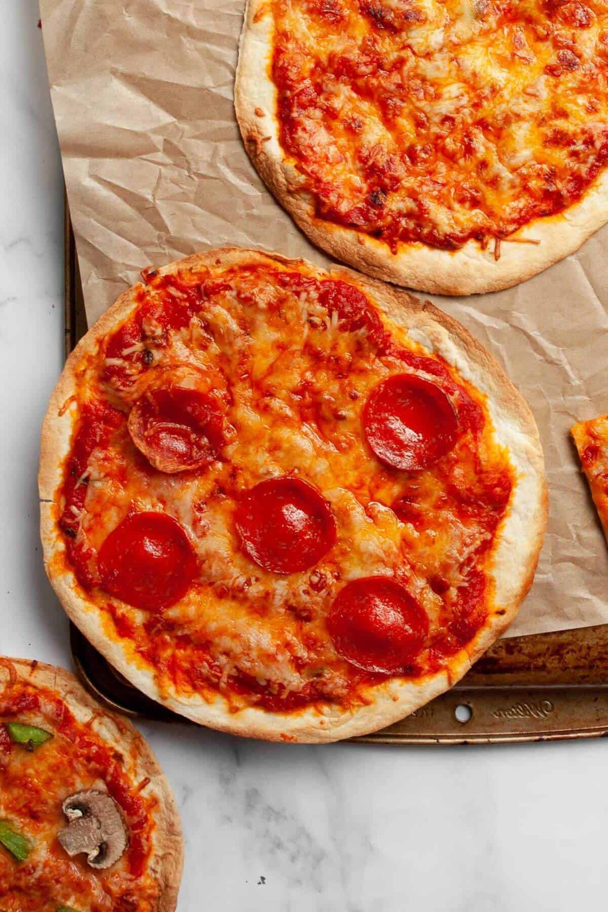 Air fryer tortilla pizza with melted cheese and crispy crust.