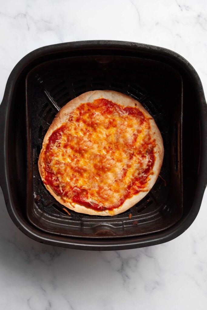 cheesy tortilla pizza cooked in air fryer basket