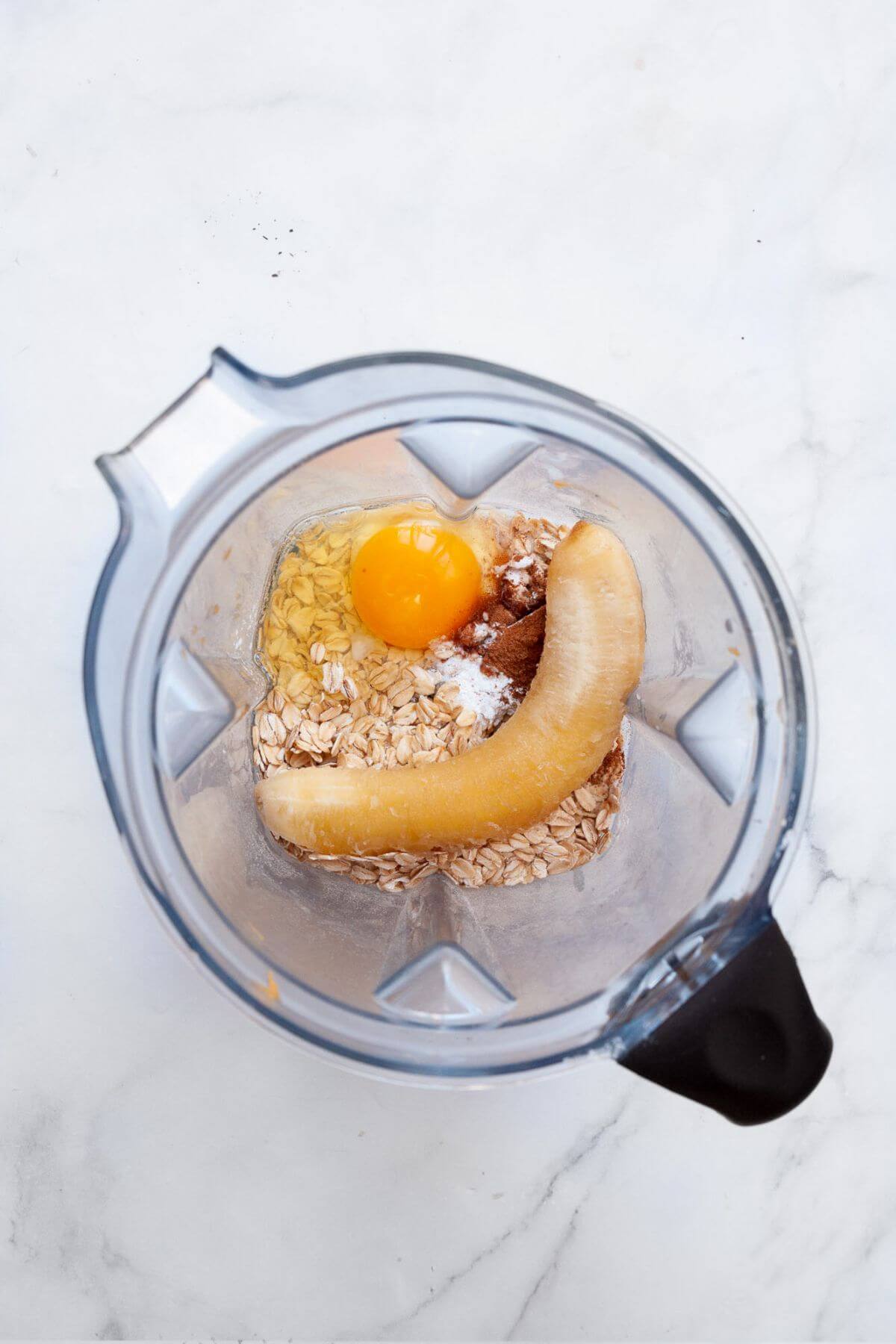 Banana, oats, egg, baking powder, milk, and cinnamon in blender.