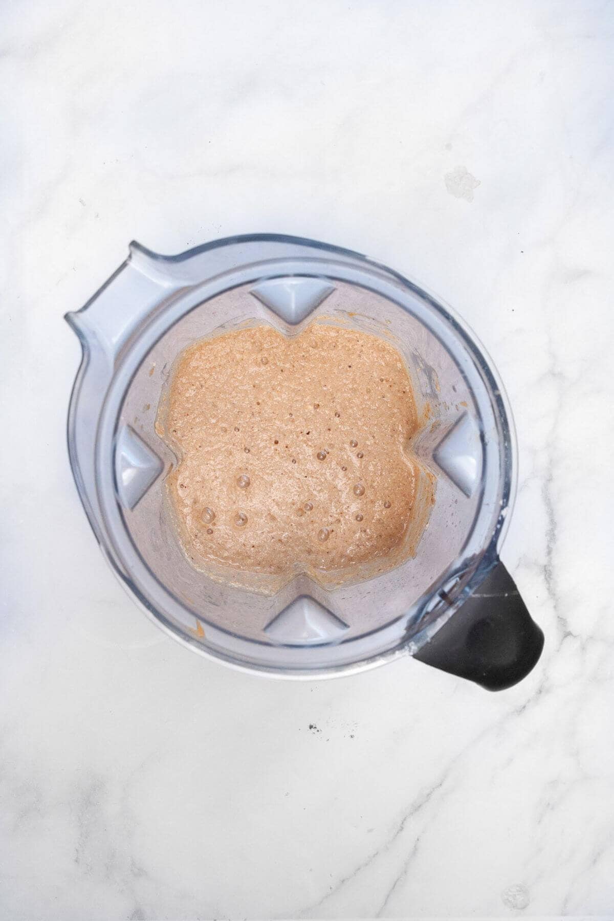 Chunky monkey oatmeal pancake batter in a blender, resting so it thickens.