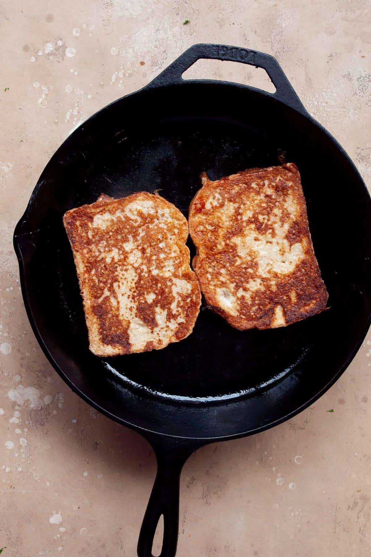 Cooking protein french toast in a skillet.