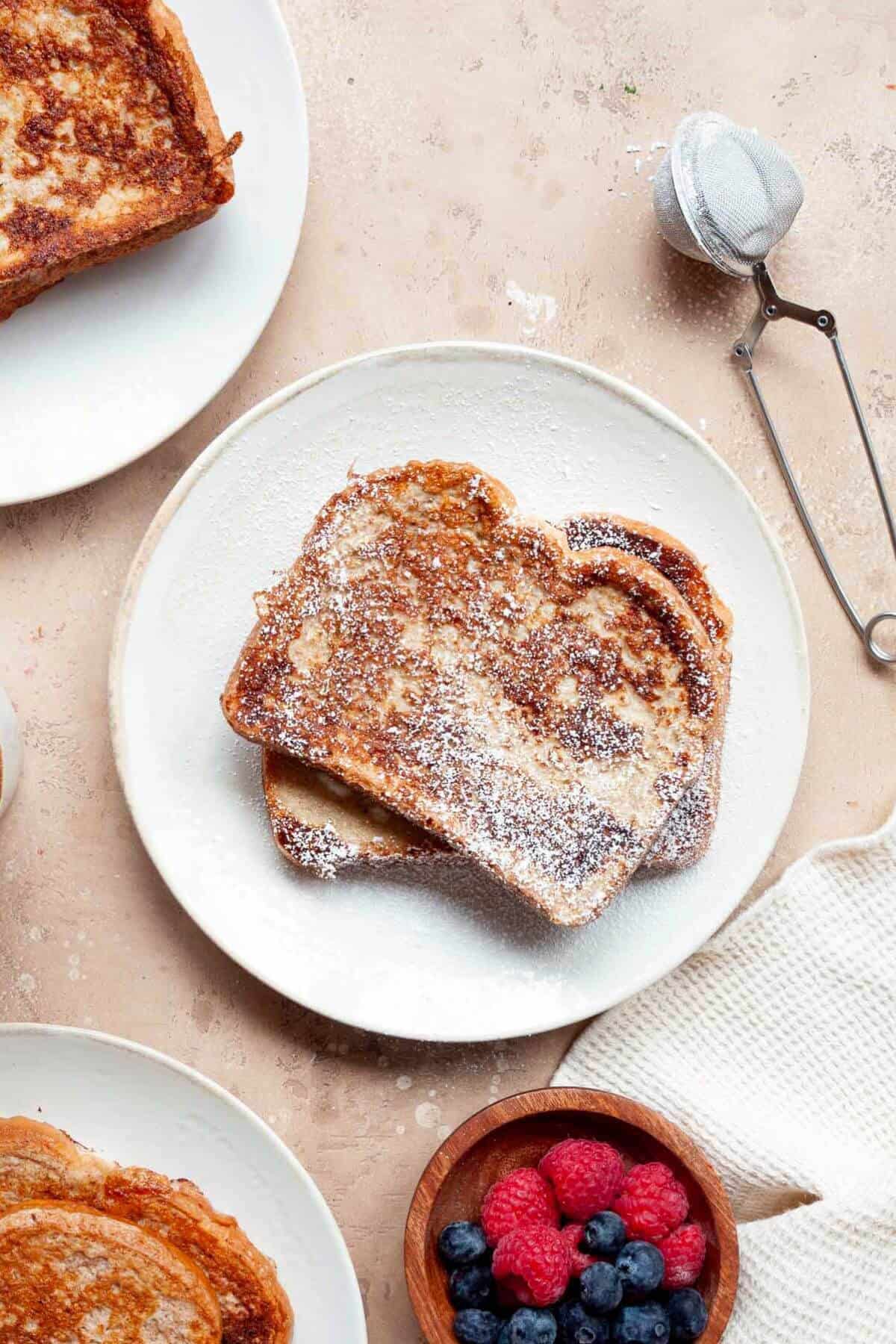 Dusting powdered sugar on top of protein french toast.