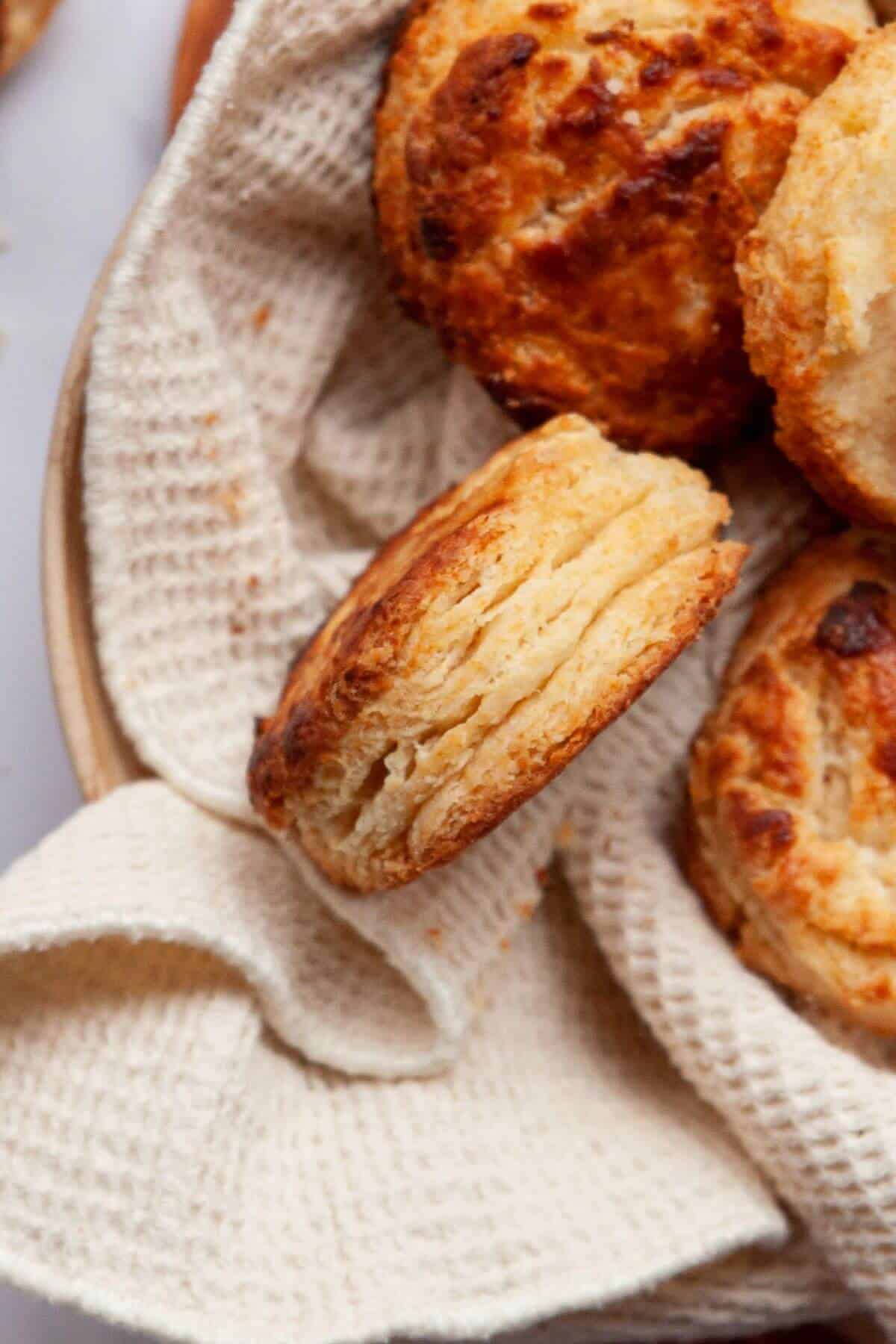 Close-up of flaky air fryer biscuit showing soft layered inside.