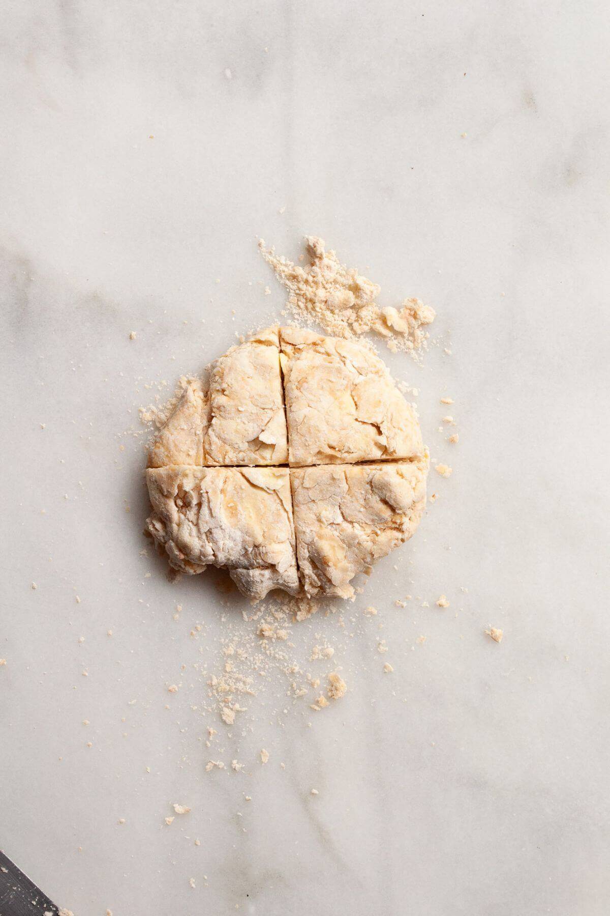 Shaggy biscuit dough on a floured surface.