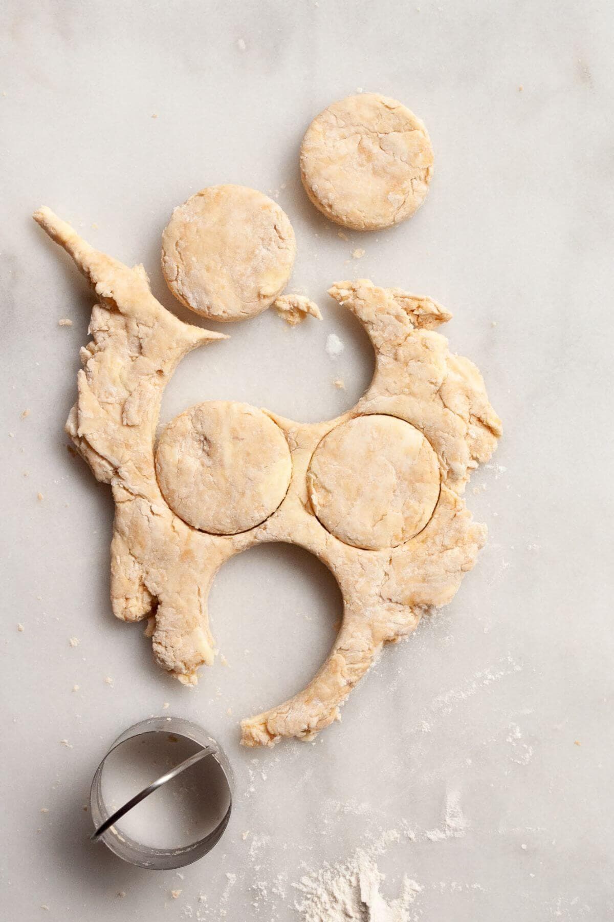 Cutting biscuit dough with a round cutter without twisting.