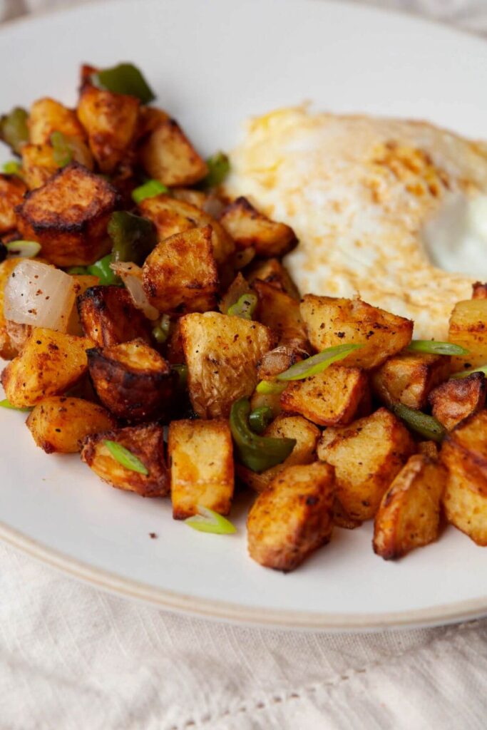 healthy home fries on a plate with an egg