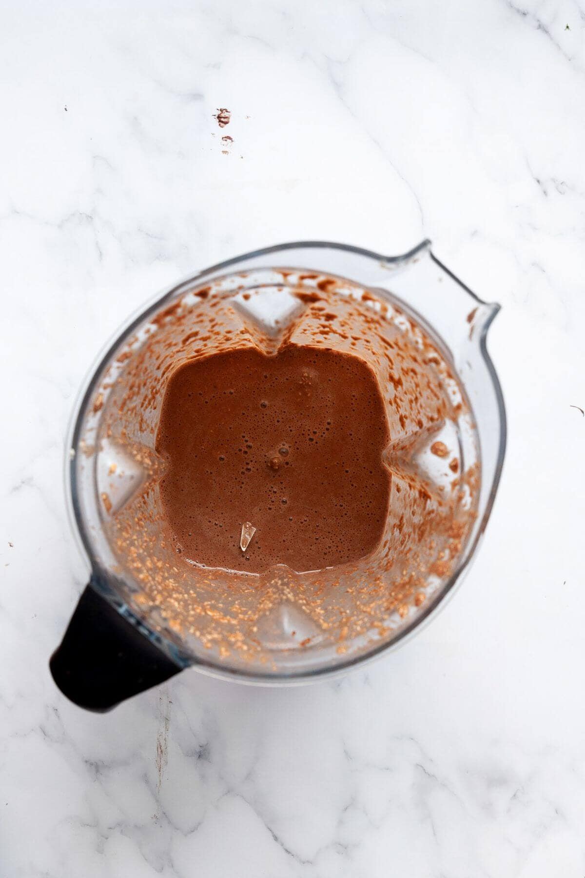 Chocolate brownie baked oats batter in a blender.