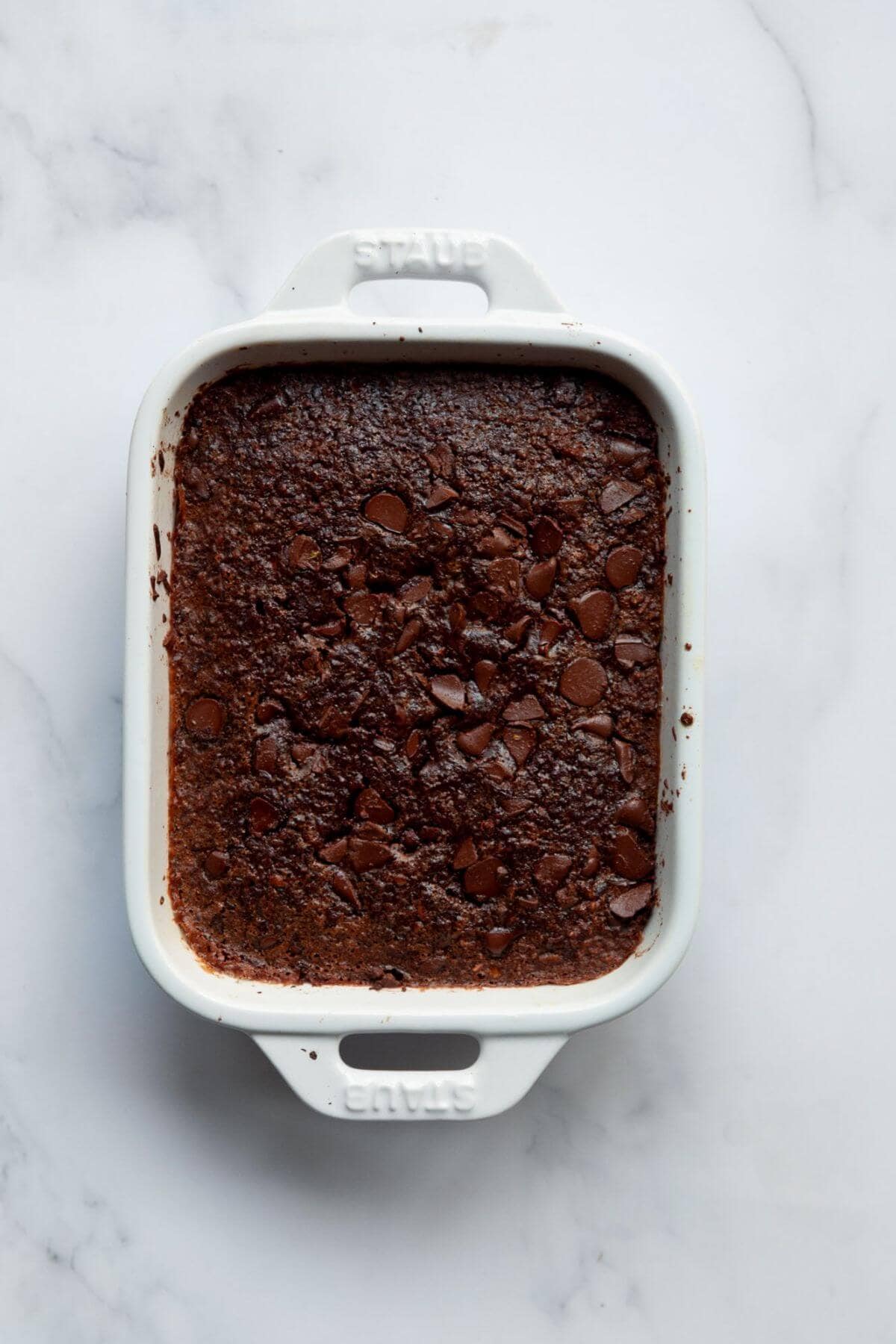 Soft and cakey chocolate baked oats in a ramekin after baking.