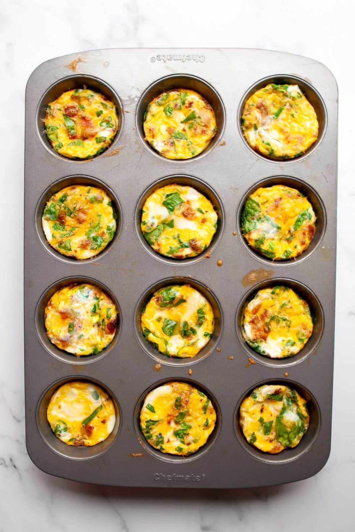 Baked keto egg bites in a 12-well muffin tin.