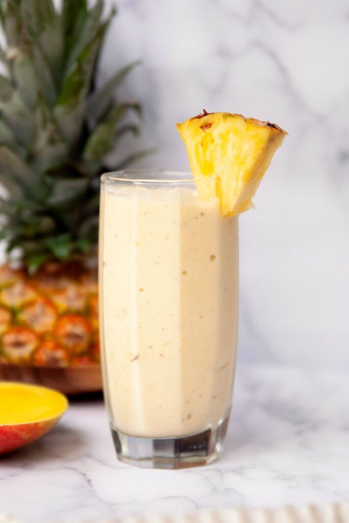 high protein mango pineapple smoothie in a glass