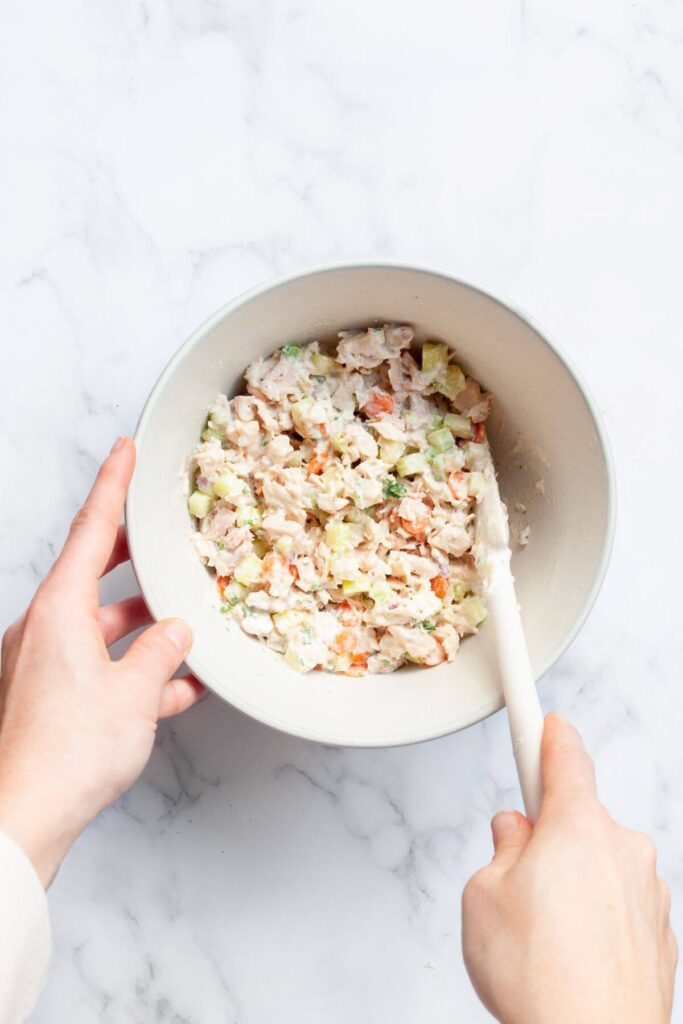 mixing healty tuna salad in a bowl