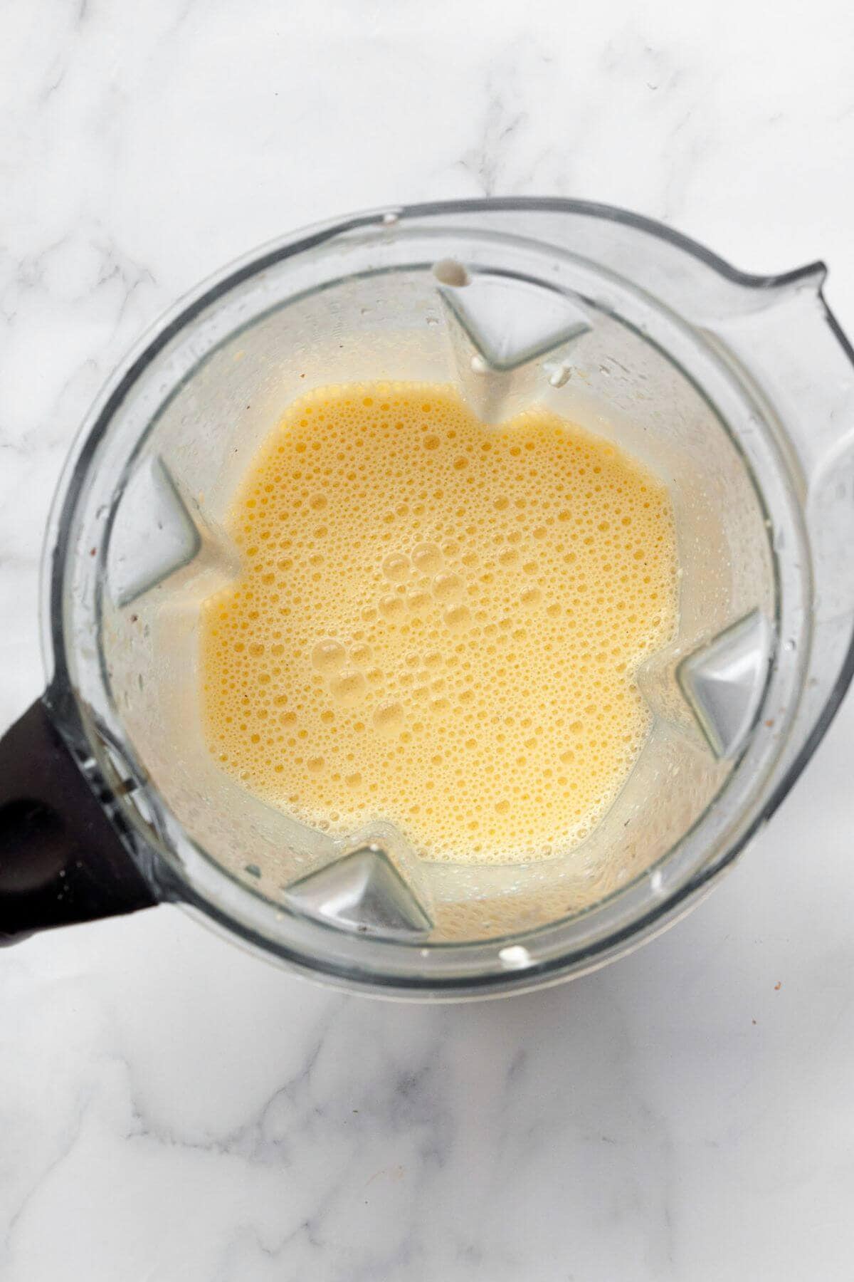 Smooth blended egg and cottage cheese mixture in a blender.