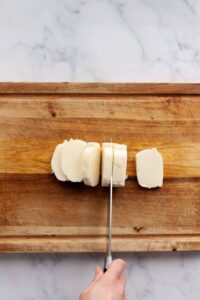 cutting a block of halloumi into pieces
