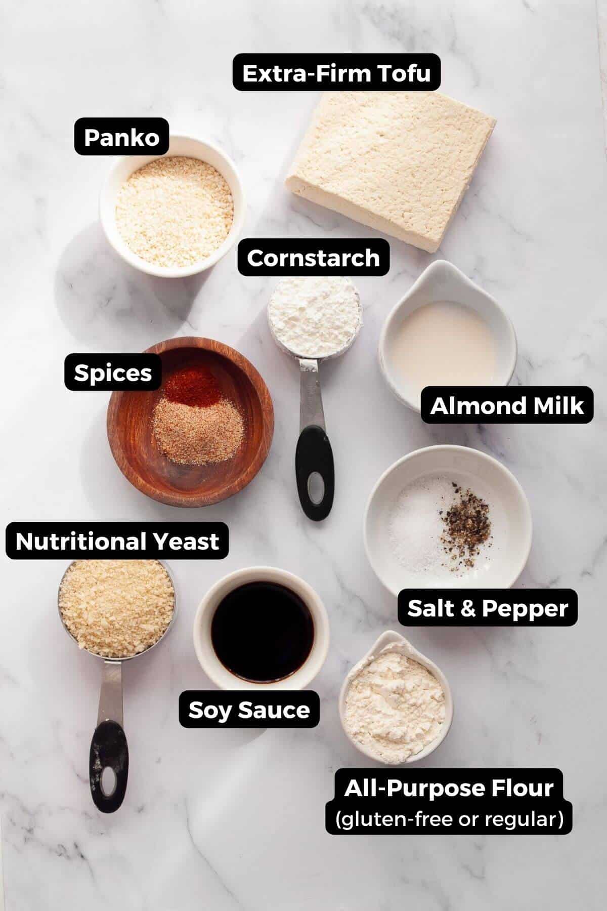 Ingredients for vegan tofu schnitzel including extra-firm tofu, panko, cornstarch, nutritional yeast, and spices.