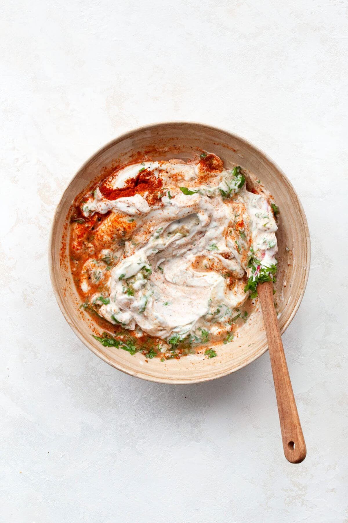 cilantro lime cream made from greek yogurt in a mixing bowl