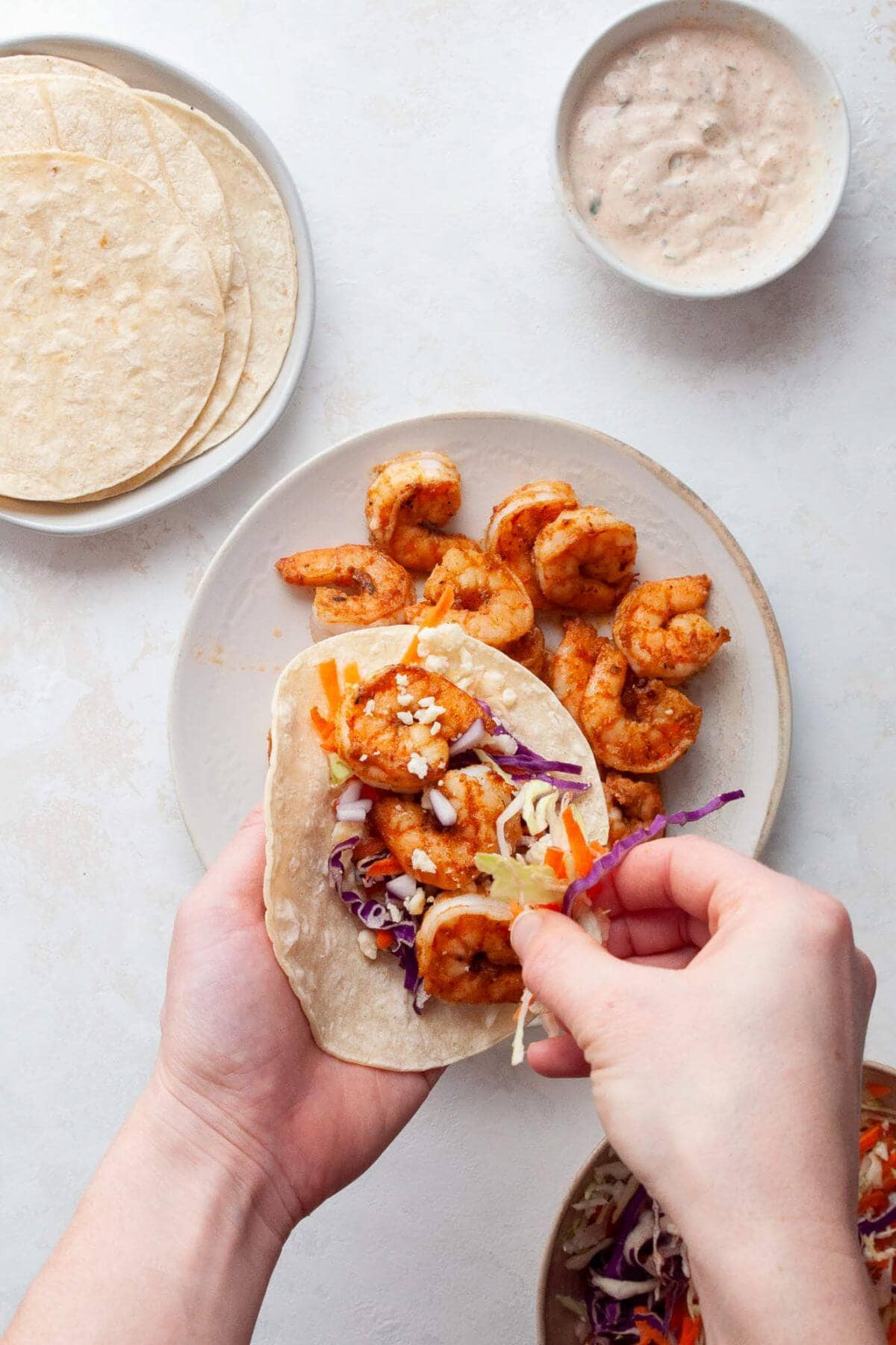 assembling healthy shrimp tacos on corn tortillas