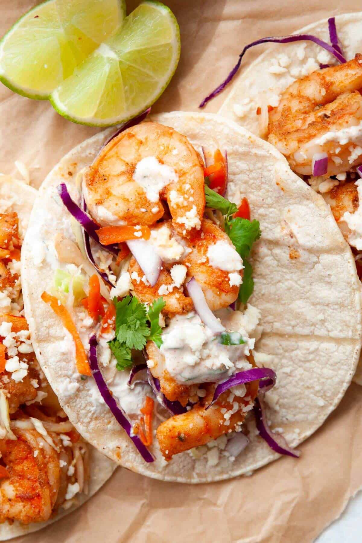 Baja shrimp tacos with cilantro lime cream drizzled on top