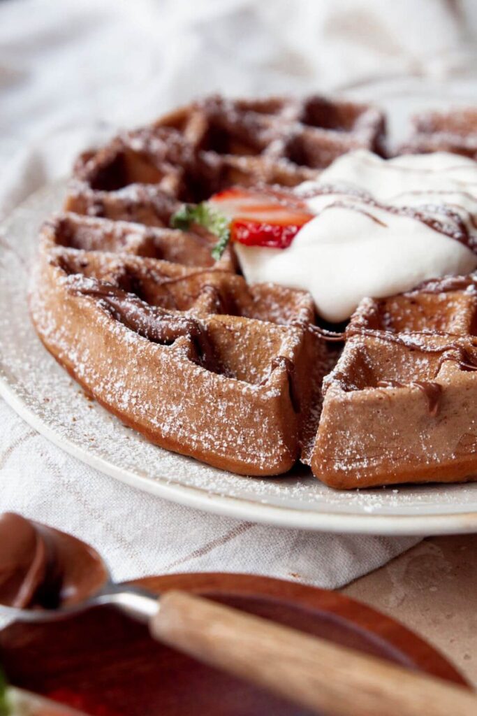side shot of a crispy and fluffy Nutella waffle