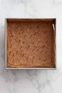 gluten-free oat flour shortbread crust in a baking dish after blind baking