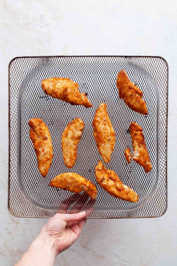 cooked chicken tenders without breading in an air fryer basket