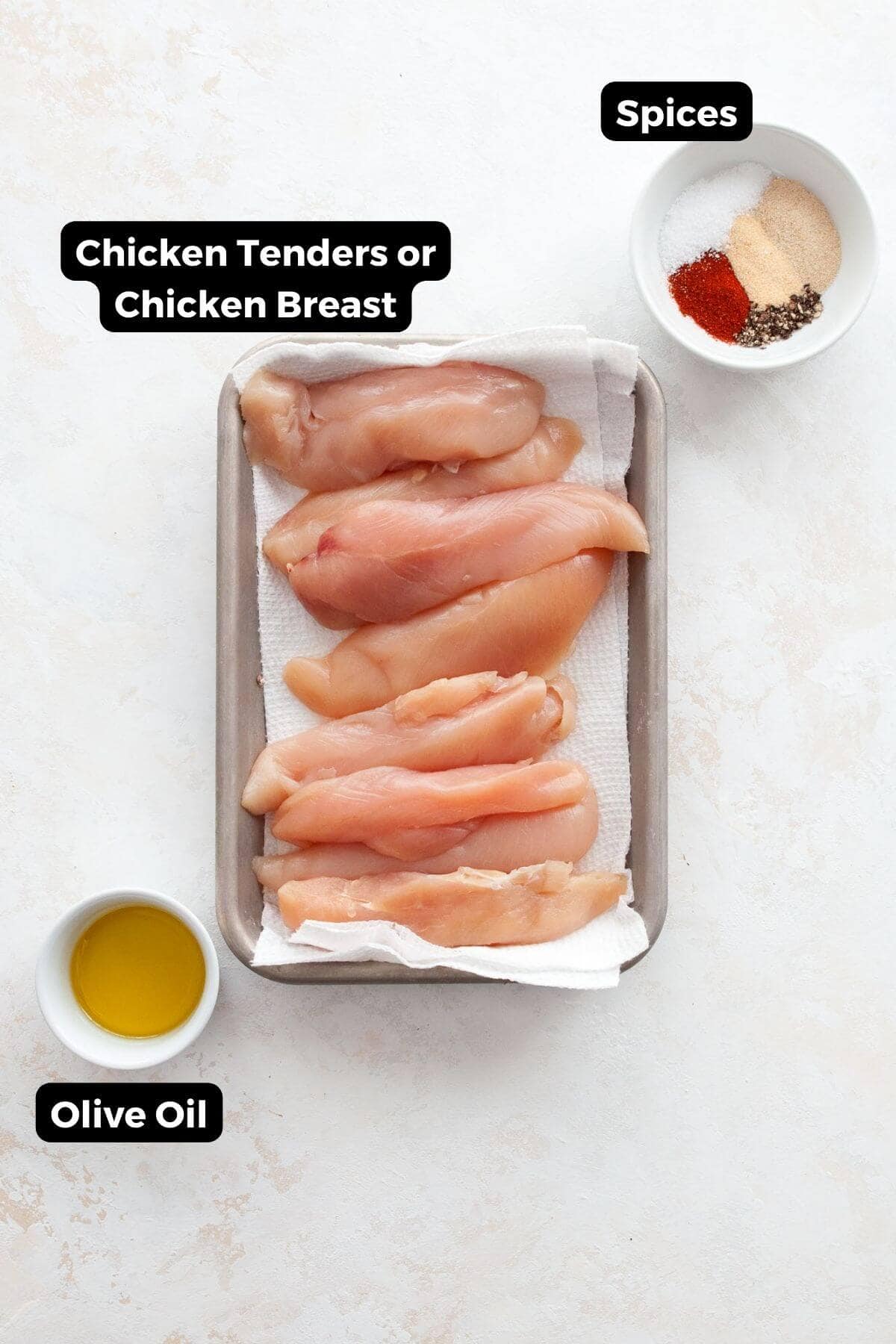 Ingredients for air fryer chicken tenders without breading: raw chicken tenderloins, olive oil, and spices.