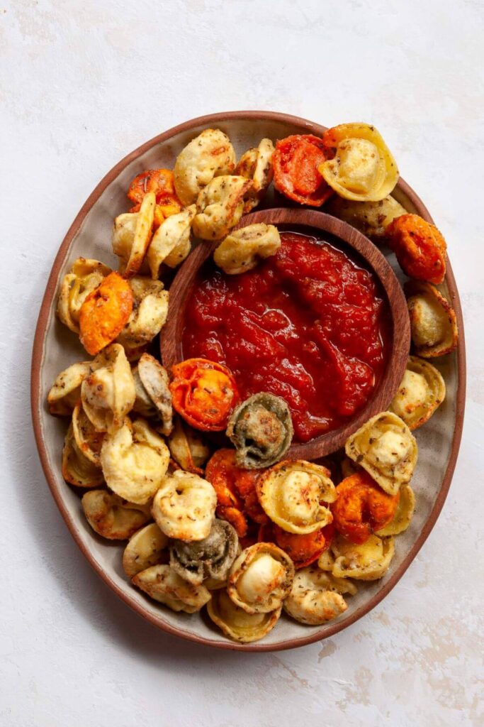 air fried tortellini on a plate with marinara dipping sauce