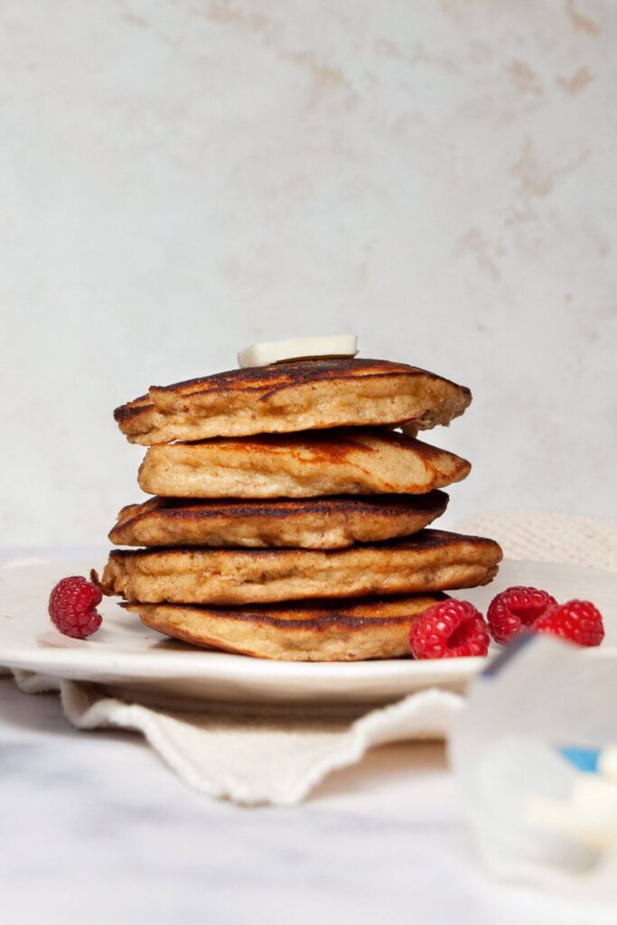 stack of almond flour banana pancakes with raspberries