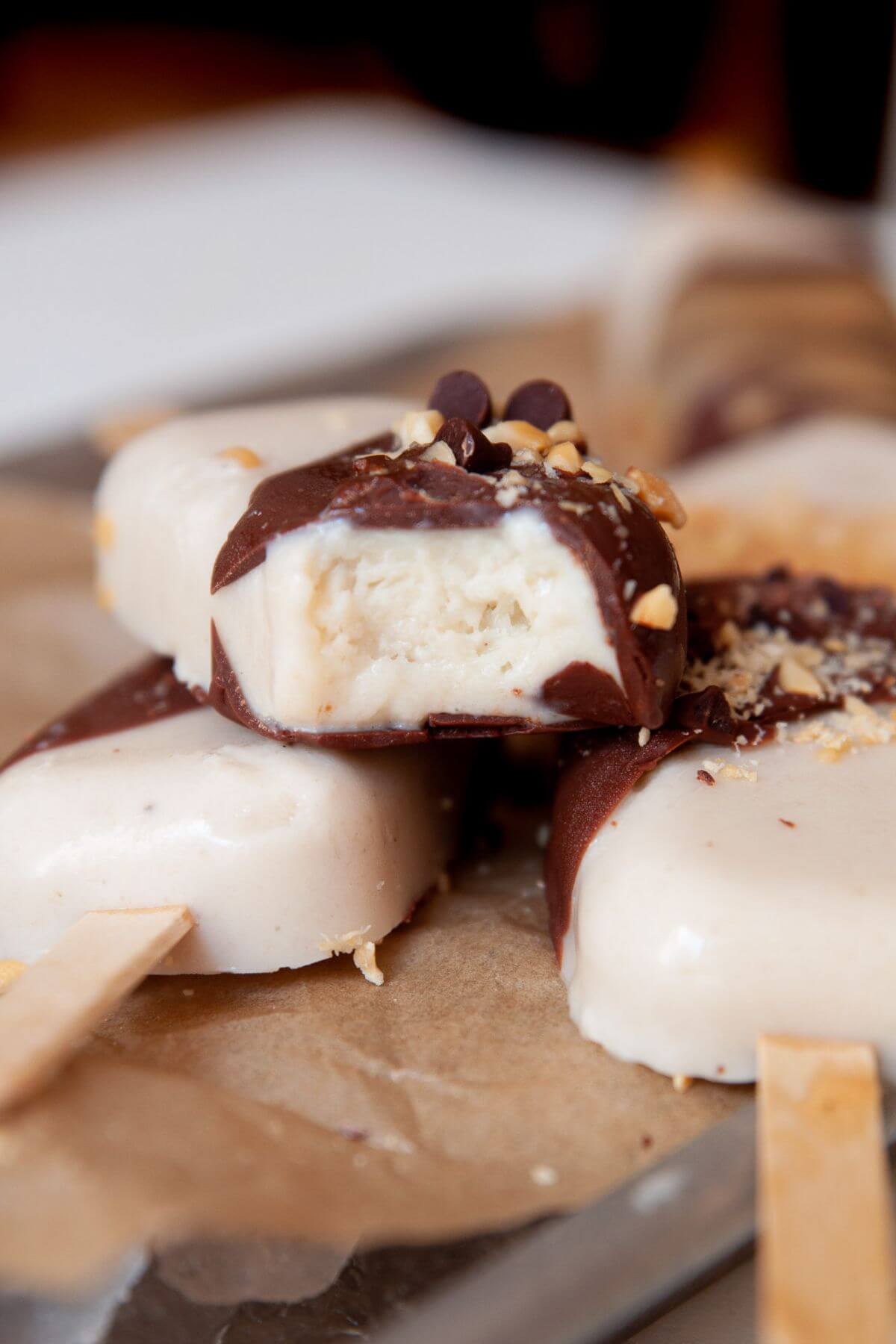 Close-up of a banana popsicle with a bite taken, showing the creamy inside