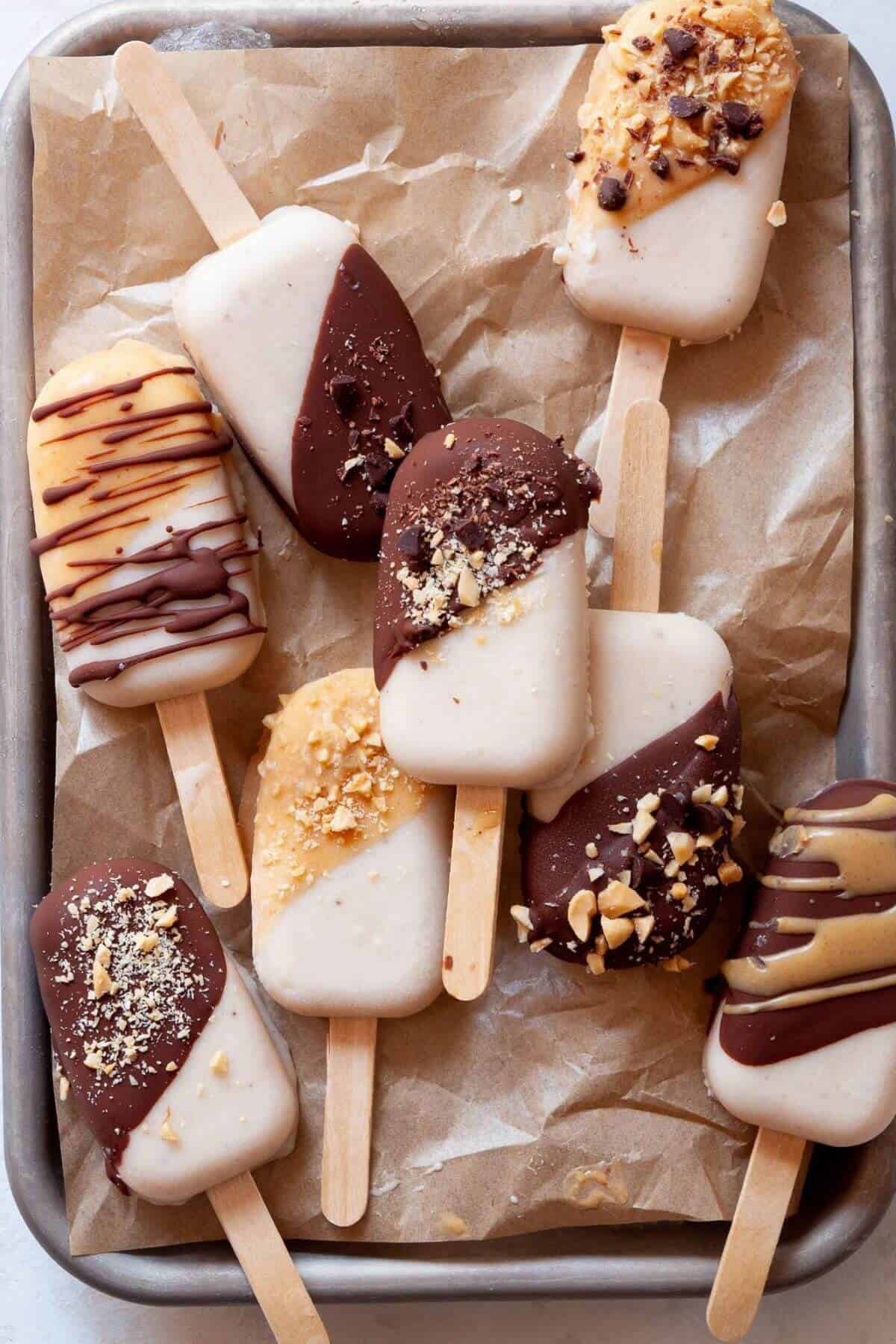 Healthy protein banana popsicles coated with glossy chocolate magic shell.