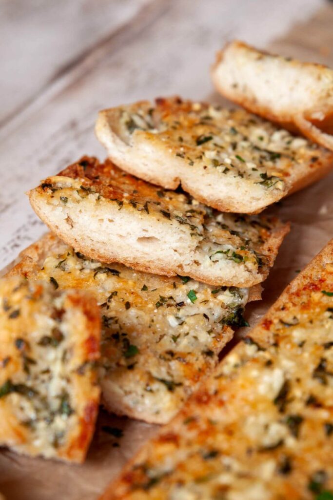buttery gluten-free garlic bread with crispy parmesan top