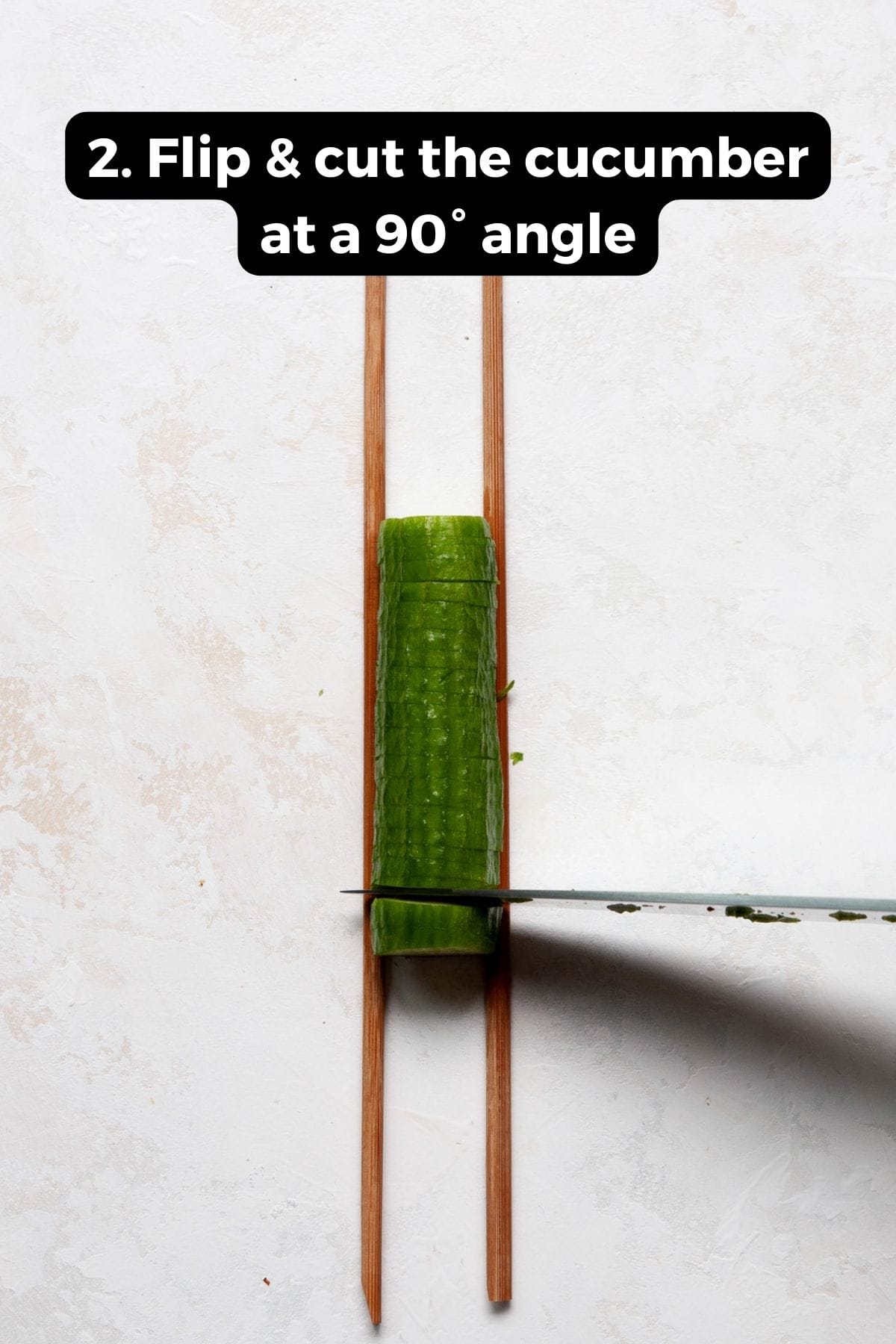 how to cut a mini cucumber at a 90-degree angle between two chopsticks to make an accordion cucumber
