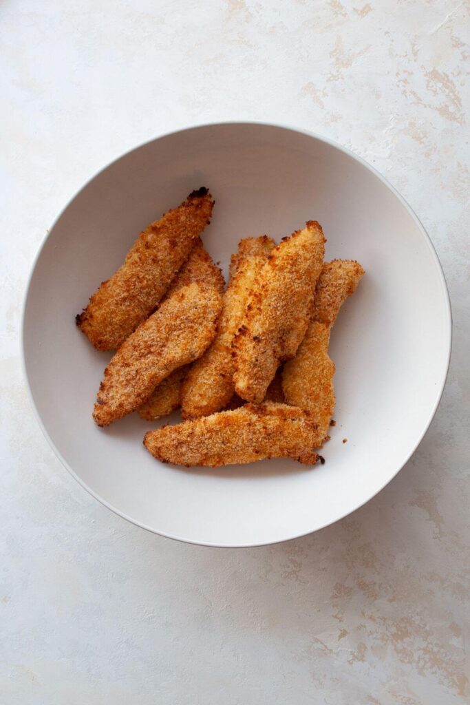 crispy chicken tenders in a mixing bowl