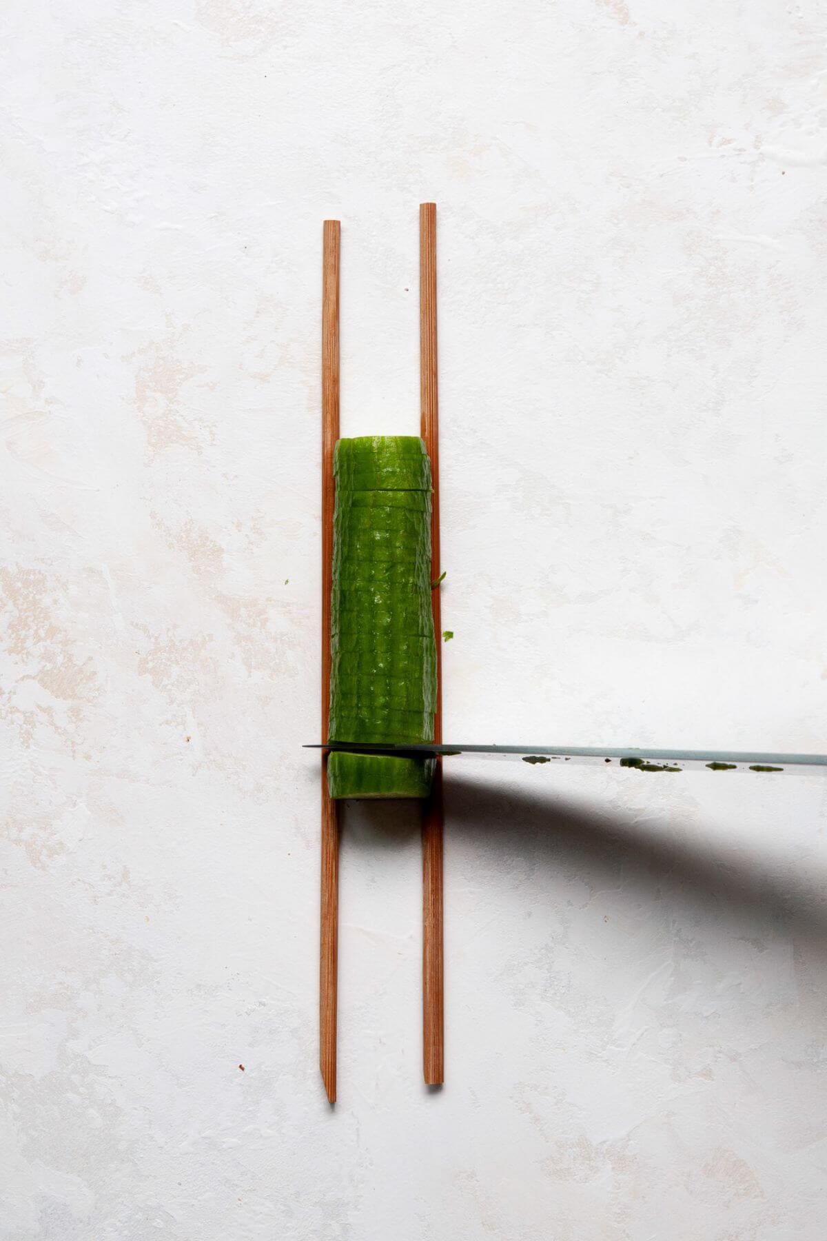 Cutting a mini cucumber into an accordion cucumber