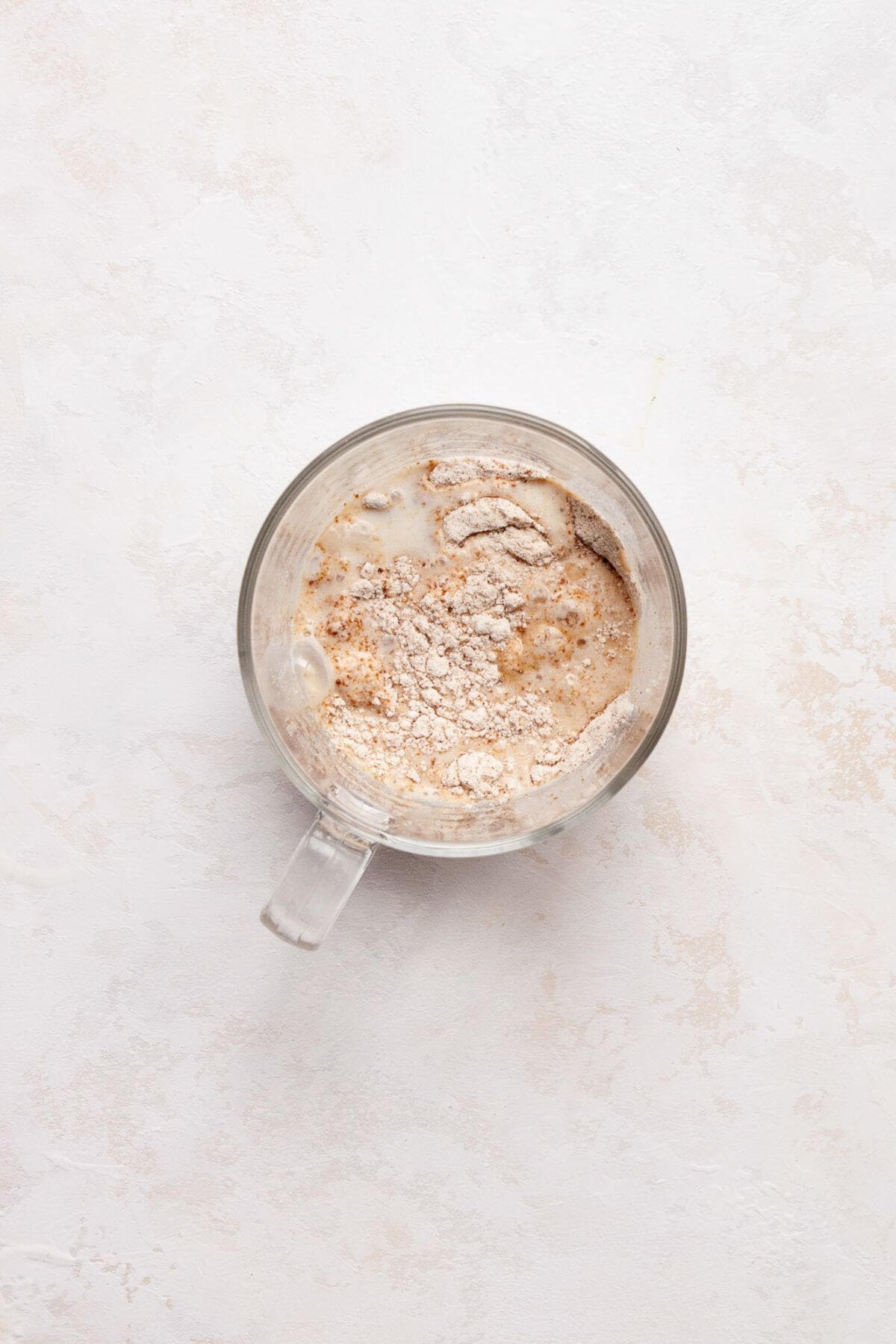 Mixing the dry ingredients with the wet ingredients in a mug.