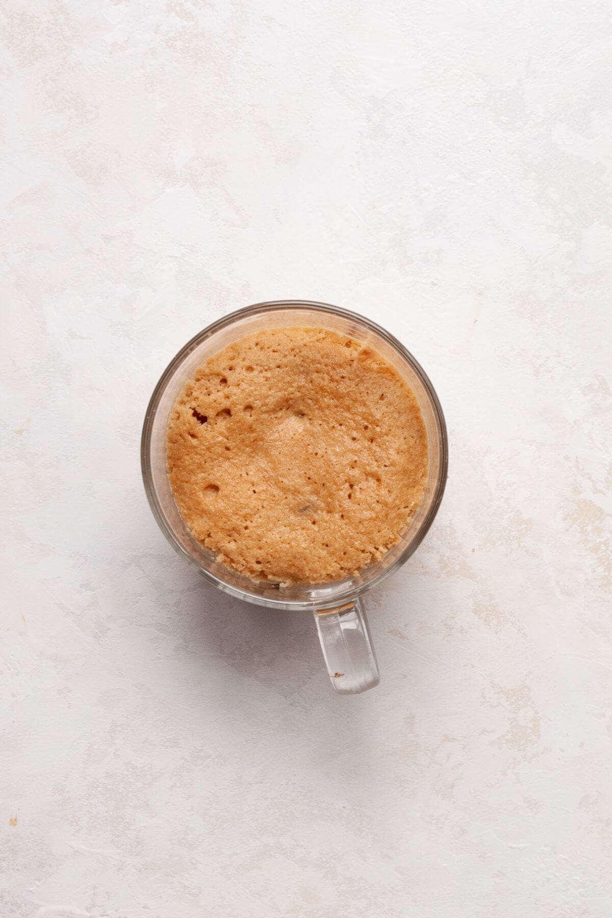 Fluffy protein mug cake after cooking in the microwave for 60 seconds.