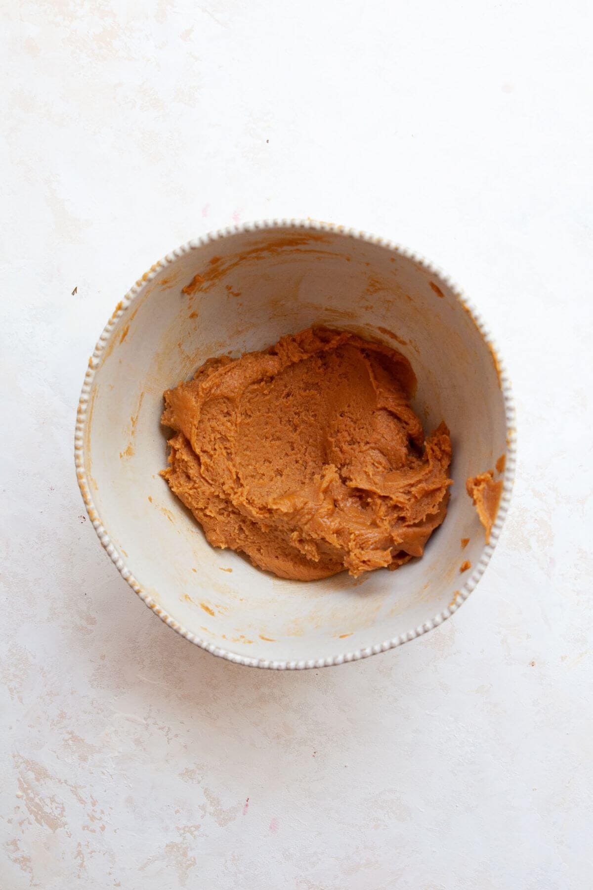 Peanut butter cookie dough mixed in a white bowl.
