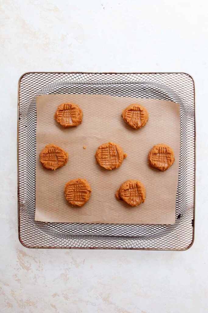 peanut butter cookie dough unbaked in an air fryer basket